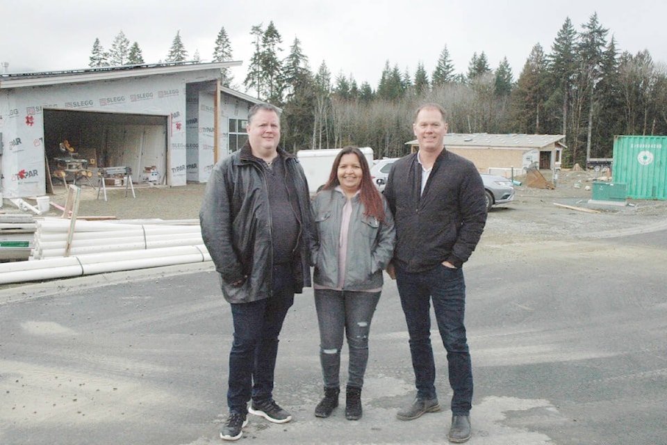 Workers and trucks are constantly on the move during the construction of the North Shore Estates housing development, which is being built by the Ts’uubaa-asatx First Nation, on North Shore Road. Pictured at phase 2 of the project is, from left, Aaron Hamilton, general manager of TSU Holdings, Melanie Livingstone, CEO of Tsu Holdings, and Brock Dupont, COO of Tsu Holdings. (Robert Barron/Gazette)