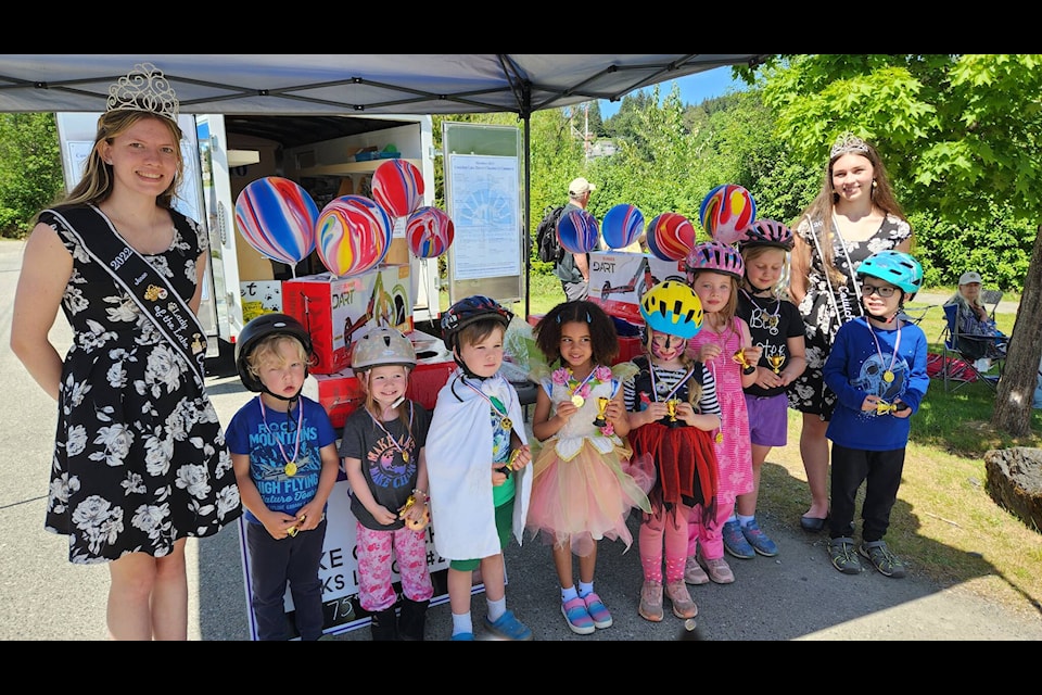 Children who participated in the Decorated Bicycle competition, flanked by two Ladies of the Lake at Heritage Days, 2023. (Kathryn Swan photo)