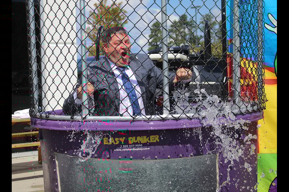 East Kootenay MLA Tom Shypitka takes a dunk in the tank at the ninth annual Hometown For Hunger event on Aug. 7