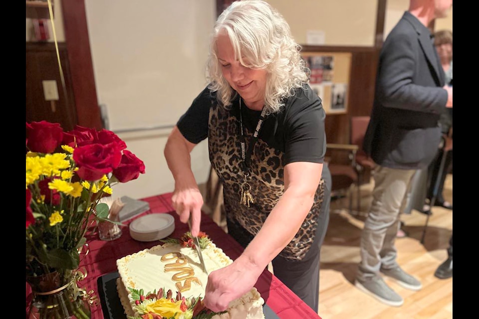 Cranbrook Community Theatre office manager Maureen Frank cuts into the cake at the 50-60 anniversary on Sept. 10 at Studio Stage Door