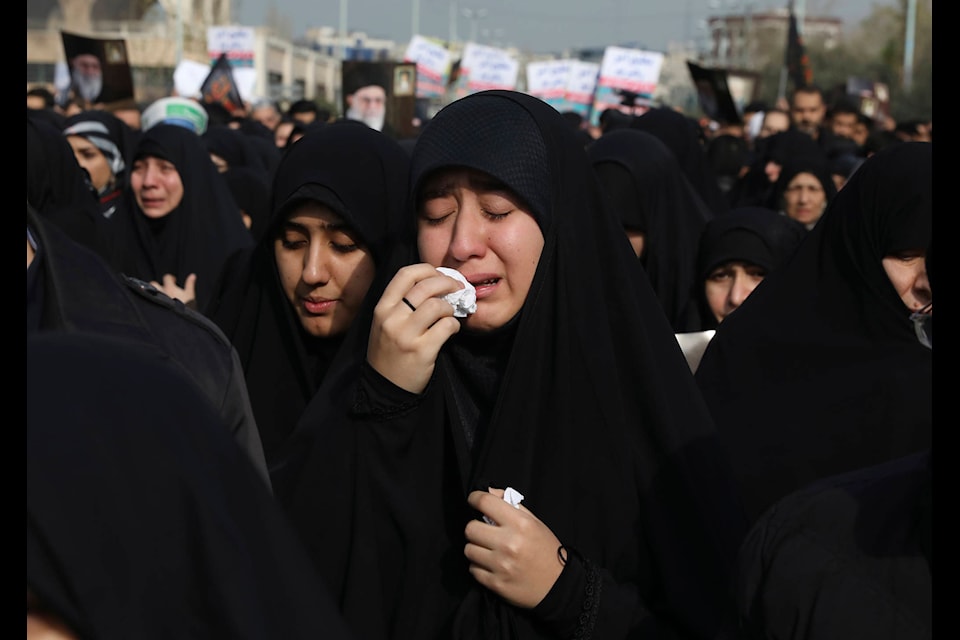 A women weeps while mourning during a demonstration over the U.S. airstrike in Iraq that killed Iranian Revolutionary Guard Gen. Qassem Soleimani, in Tehran, Iran, Jan. 3, 2020. Iran has vowed “harsh retaliation” for the U.S. airstrike near Baghdad’s airport that killed Tehran’s top general and the architect of its interventions across the Middle East, as tensions soared in the wake of the targeted killing. (AP Photo/Vahid Salemi)