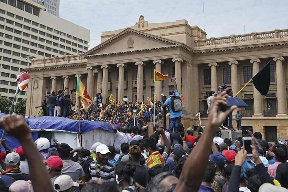 Protesters, many carrying Sri Lankan flags, gather outside the presidents office in Colombo, Sri Lanka, Saturday, July 9, 2022. Sri Lankan protesters stormed President Gotabaya Rajapaksa’s residence and nearby office on Saturday as tens of thousands of people took to the streets of the capital Colombo in the biggest demonstration yet to vent their fury against a leader they hold responsible for the island nation’s worst economic crisis. (AP Photo/Thilina Kaluthotage)