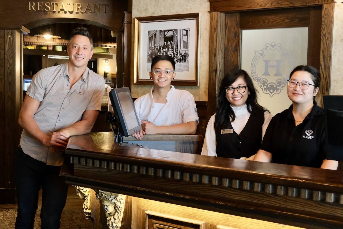Hume Hotel general manager Ryan Martin with three current or former Selkirk College international students working at the hotel, L-R: Kim Ison, Kristine (Tin Tin) Tono and Alifia Lepcha. Photo: Bill Metcalfe