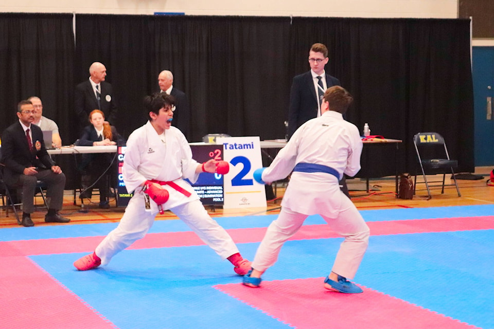 Vancouver Coastal karate athlete Haumi Tarighatbin (red) faces off against Cancouver Island Central Coast athlete Hudson Ball Saturday, March 25, 2023, during the Greater Vernon B.C. Winter Games at Kalamalka Secondary School. (Brendan Shykora - Morning Star)