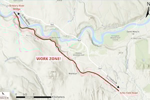 City chipping brush piles on Rails to Trails this week