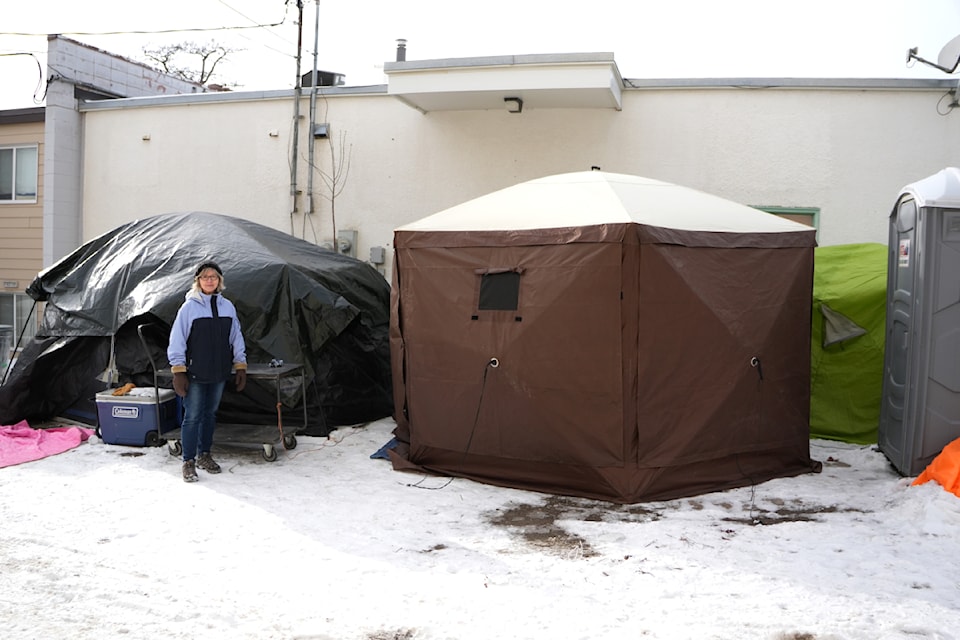 Nancy DeVuono, board chair of the Creston Valley Den Society, poses near the unhoused tent encampment in February 2025. 