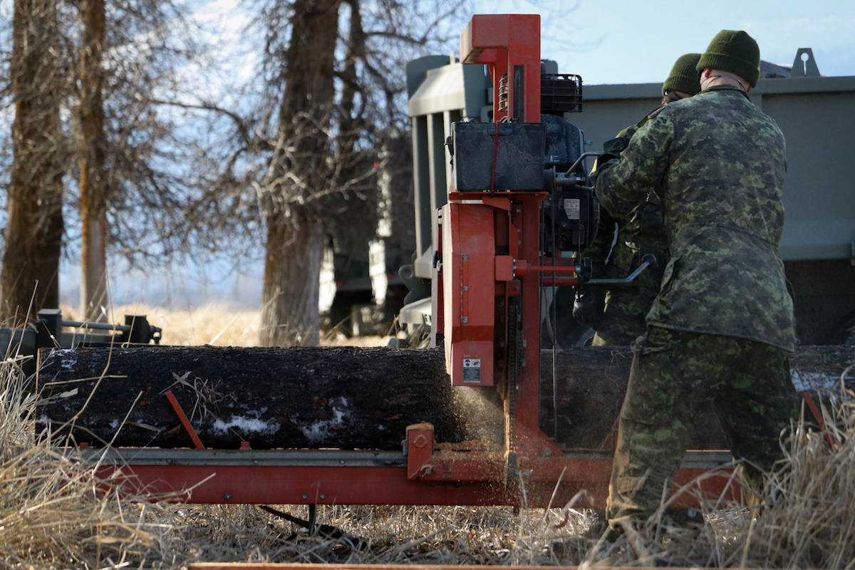 Soldiers mill lumber. Photo: Aaron Hemens