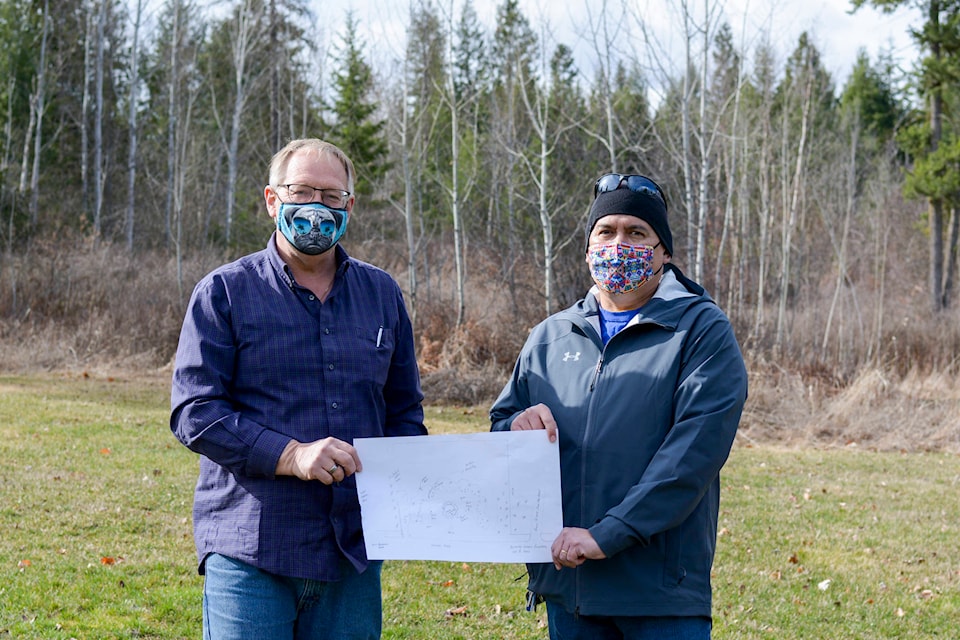 A new park is under development for the Lower Kootenay Band. Ken White, facility and operations manager, holds up the draft plans with Nasukin Jason Louie on the construction site. (Photo by Kelsey Yates)