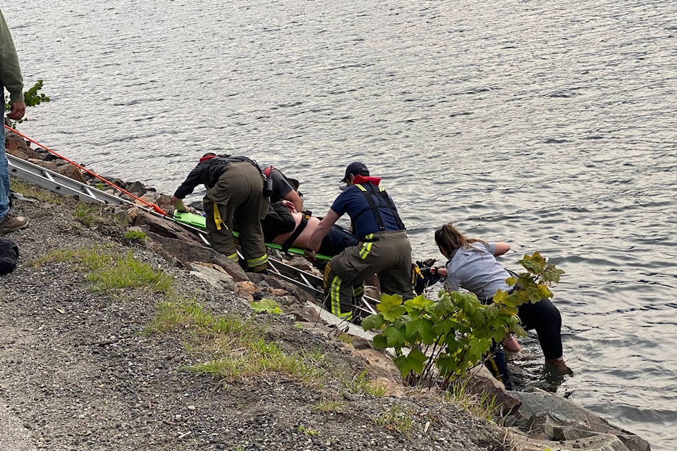 Emergency crews tend to a person rescued from Harrison Lake after witnesses say they were saved from a submerged vehicle. (Photo/Dave Pinton)