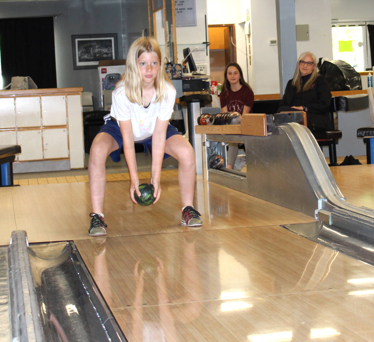 Carys Rodgers practising at Castle Bowl while coach Brenda Zoobkoff and teammate Summer Merwin cheer her on. Photo: Betsy Kline