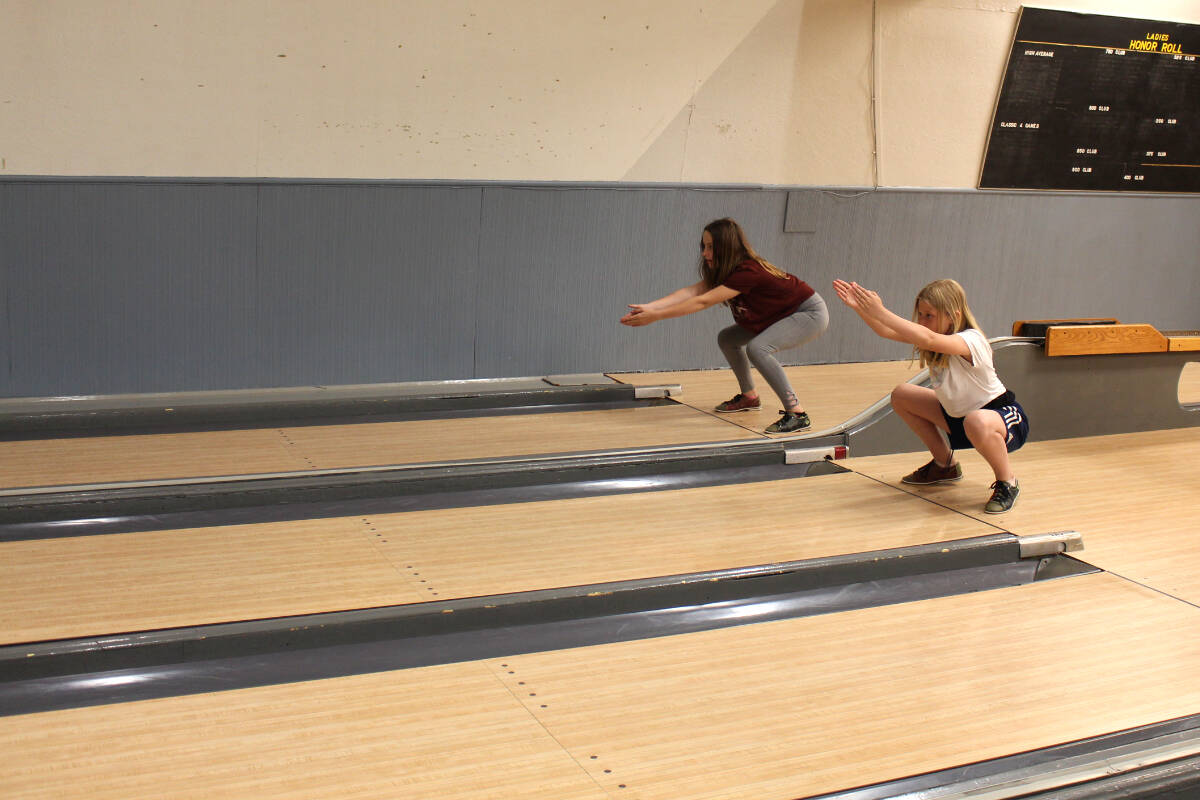 At 10 years of age, (L-R) Summer Merwin and Carys Rodgers throw their balls with two hands. They will transition to single-handed throws next year. Photo: Betsy Kline