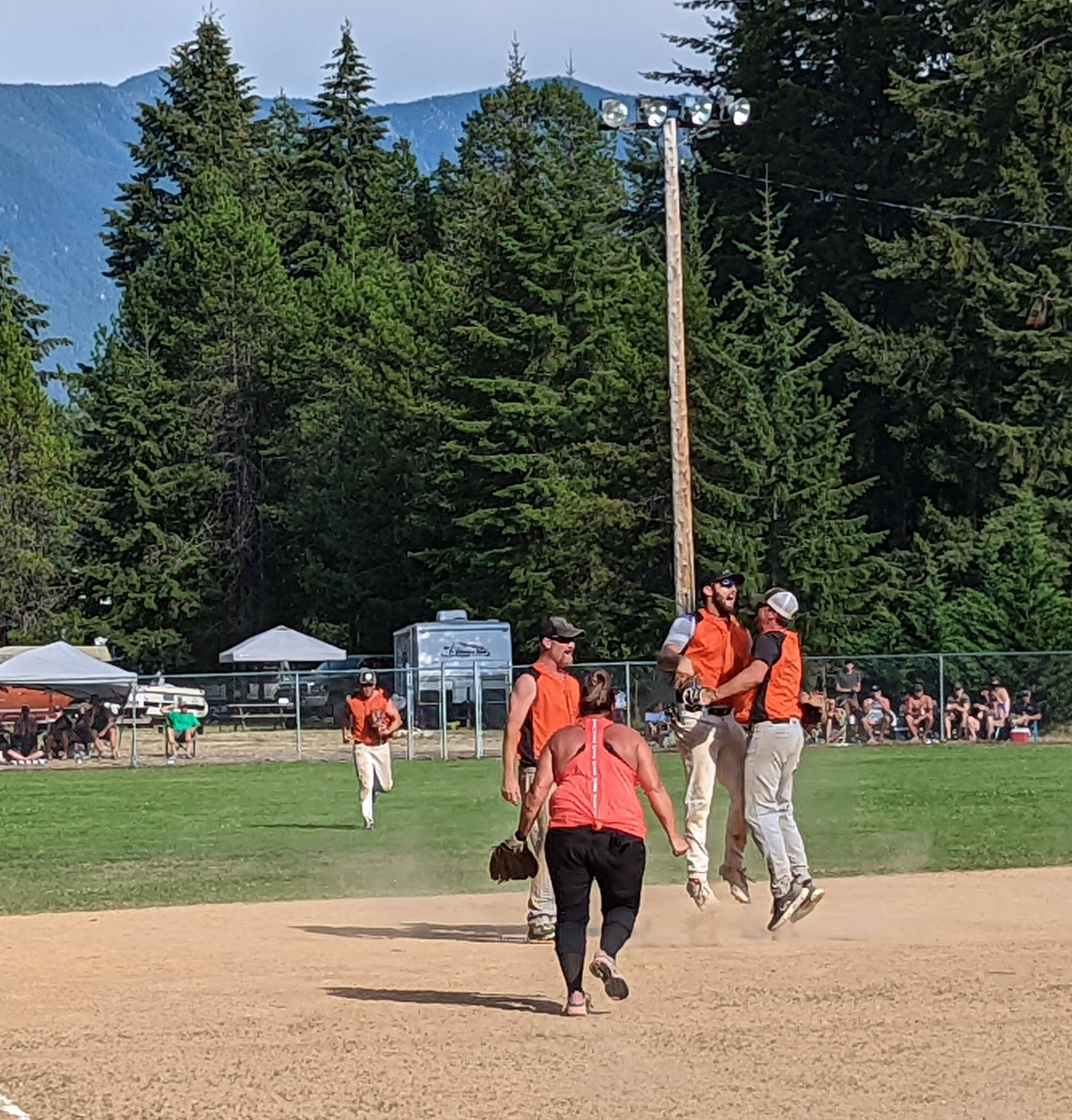 Team members Ryley Ducharme and Devon Howarth share a victory chest bump on the ball diamond. (Submitted)