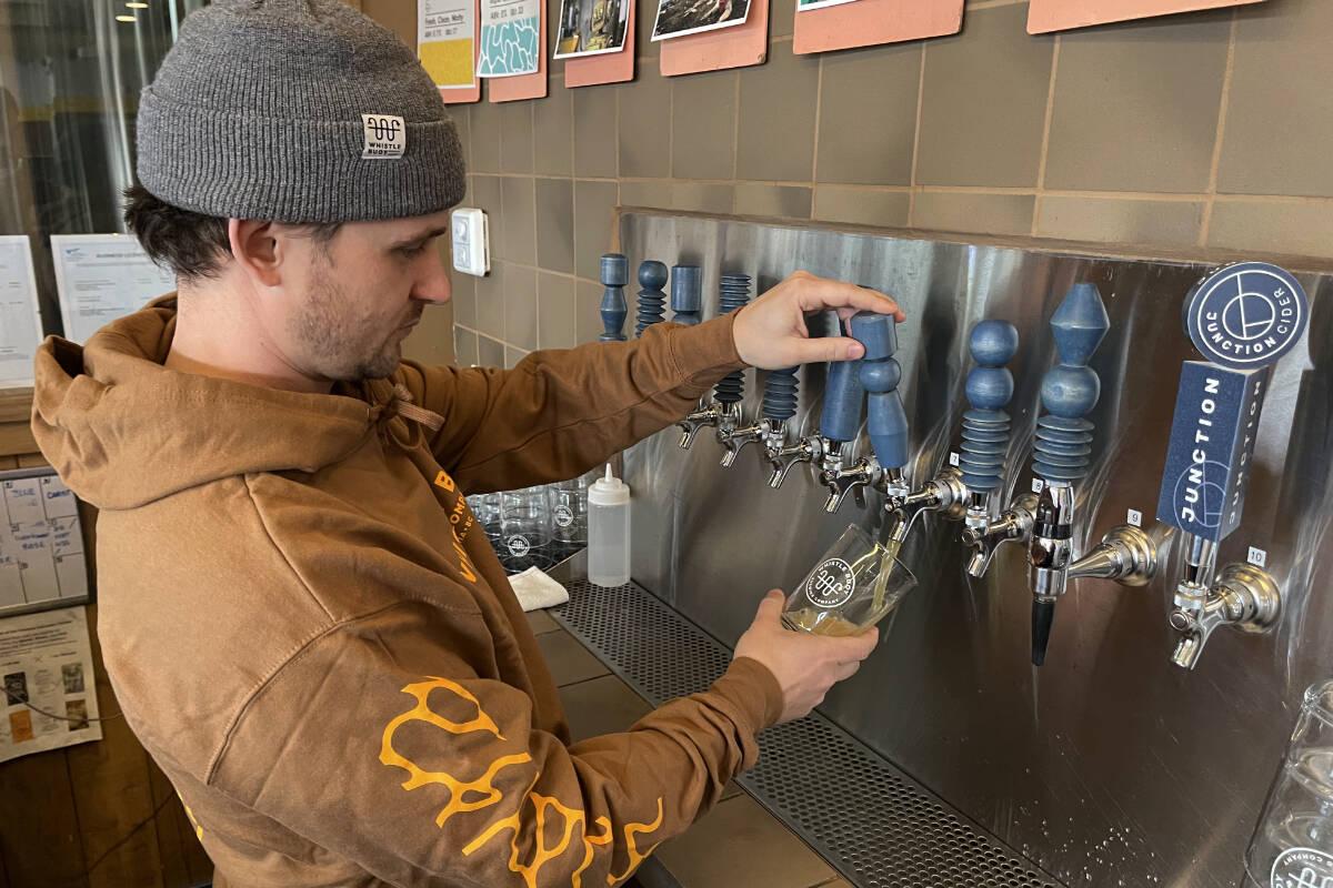Isaiah Archer pours a pint of Whistle Buoy Brewings new AI-generated hazy pale ale. (Austin Westphal/News Staff)