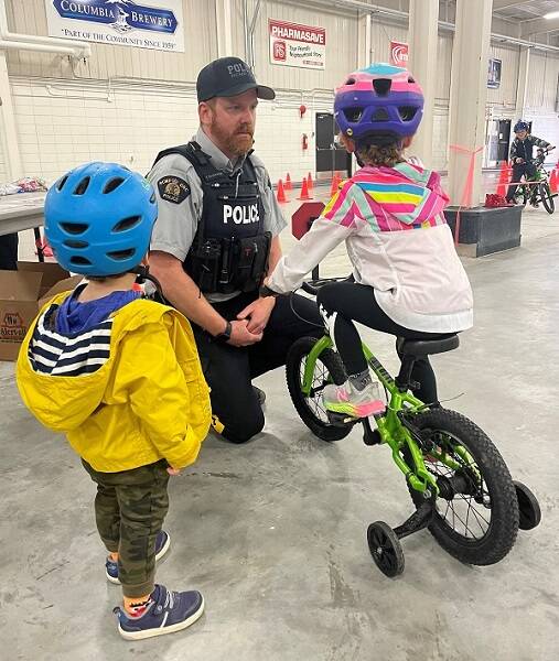 A Creston officer teaches kids about bike safety. (Courtesy of Creston RCMP)