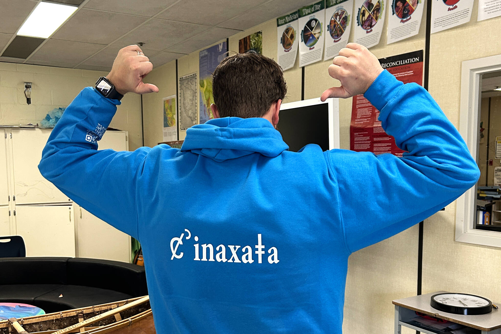 Principal Brian Hamm shows off the canoe counselling program name on a custom-designed hoodie. (Photo by Kelsey Yates)
