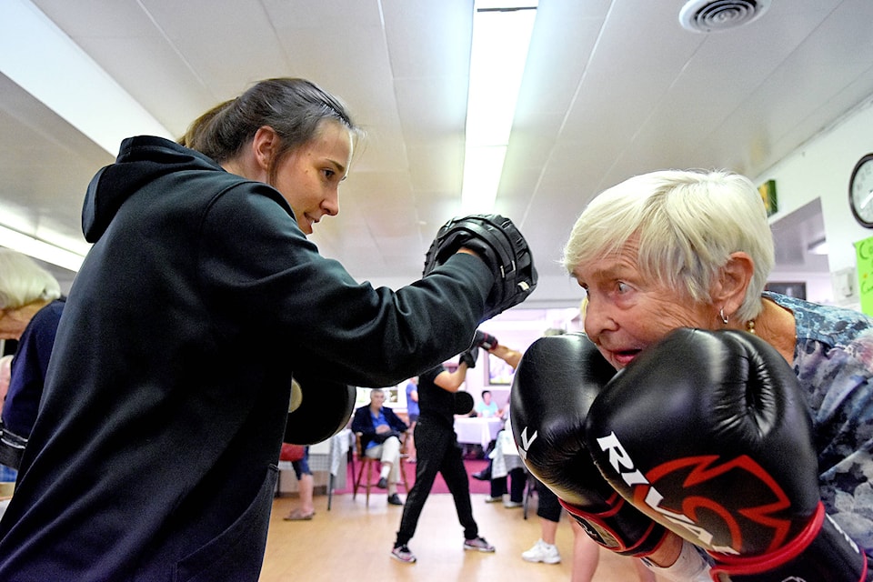 Bulldogs Boxing Club coach Jordan Konrad has Deniece Apeldoorn dodging and weaving during a lesson at the Active Agers Open House held Friday, Aug. 24 at the Shuswap Lake Senior Citizens Drop-In Centre. (Lachlan Labere/Salmon Arm Observer)