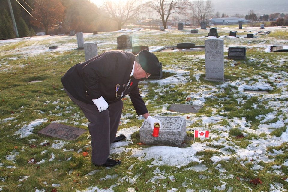 Members of the Chase Legion Branch #107 place candles at the graves of those who fought in the First World War during an Armistice 100 ceremony held on Nov. 11. (Dave Smith photo)