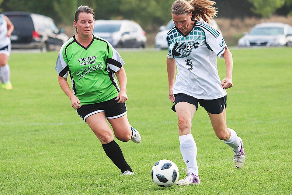 Courtesy Motors Sistas defender Corrie Folk tries to chase down Leah Foreman of the Shuswap Kaos on the final night of play in the North Okanagan Women’s Soccer Masters Division Wednesday at Marshall Field in Vernon. The Kaos won 4-0. (Roger Knox - Vernon Morning Star)