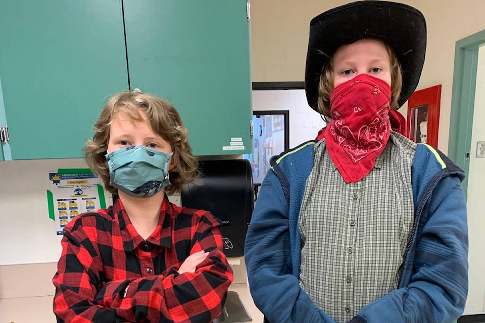 Anika Kennedy’s red and black plaid matches Zeth Oberle-Spyker’s red bandana and black hat combo on May 26 at Parkview Elementary School. (Contributed)