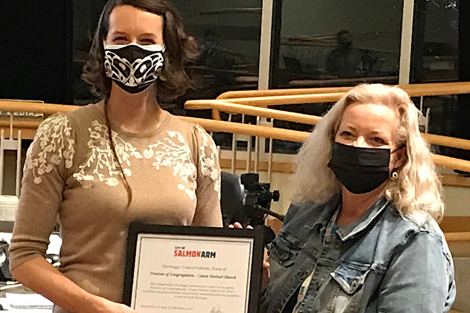 Leanne Dorrish accepts a Heritage Conservation Award from Salmon Arm Coun. Debbie Cannon for Canoe United Church, now 100 years old and still standing strong. (Pat Kassa photo)