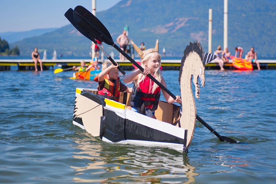 Elise and August Shannon race back to the beach in their vessel Gramhalla, designed to reflect their Swedish heritage, to take first place in the first heat of the cardboard boat race during Sicamous Family Fun Day at Beach Park on Saturday, July 30, 2022. (Lachlan Labere-Eagle Valley News)