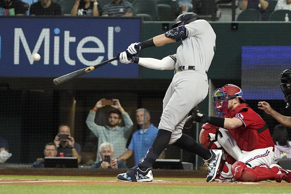 New York Yankees’ Aaron Judge hits a solo home run, his 62nd of the season, during the first inning in the second baseball game of a doubleheader against the Texas Rangers in Arlington, Texas, Tuesday, Oct. 4, 2022. With the home run, Judge set the AL record for home runs in a season, passing Roger Maris. (AP Photo/LM Otero)