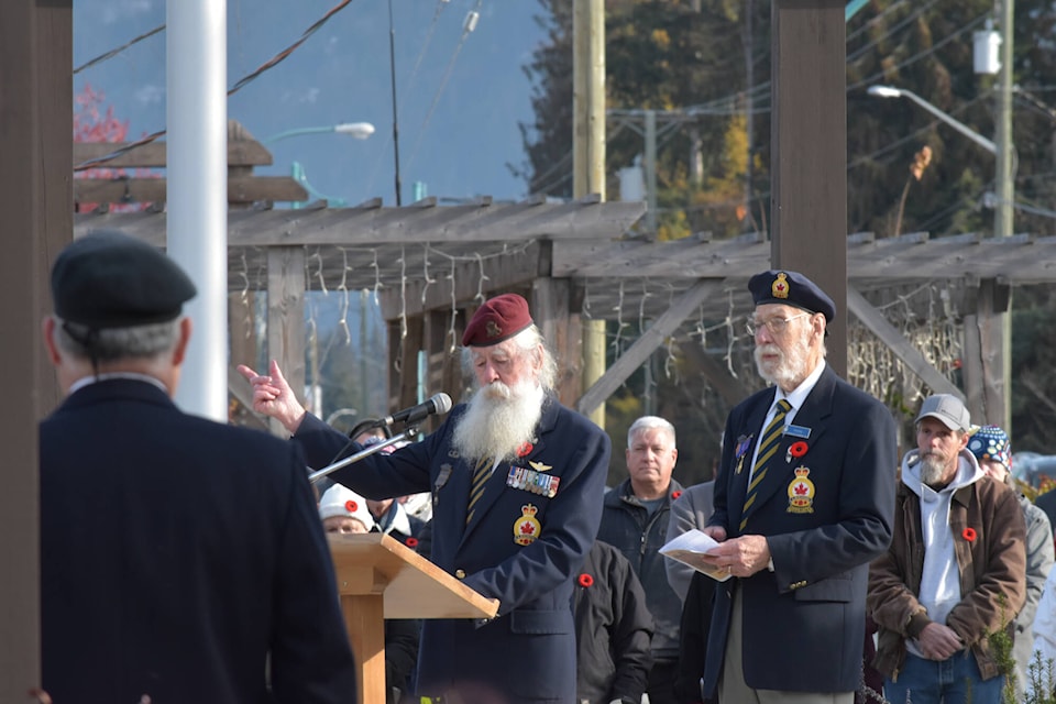 Sicamous veteran Al Stevens gestures for the crowd to finish the Act of Remembrance recitation at the Sicamous Legion Remembrance Day ceremony, Nov. 11. (Rebecca Willson- Eagle Valley News)