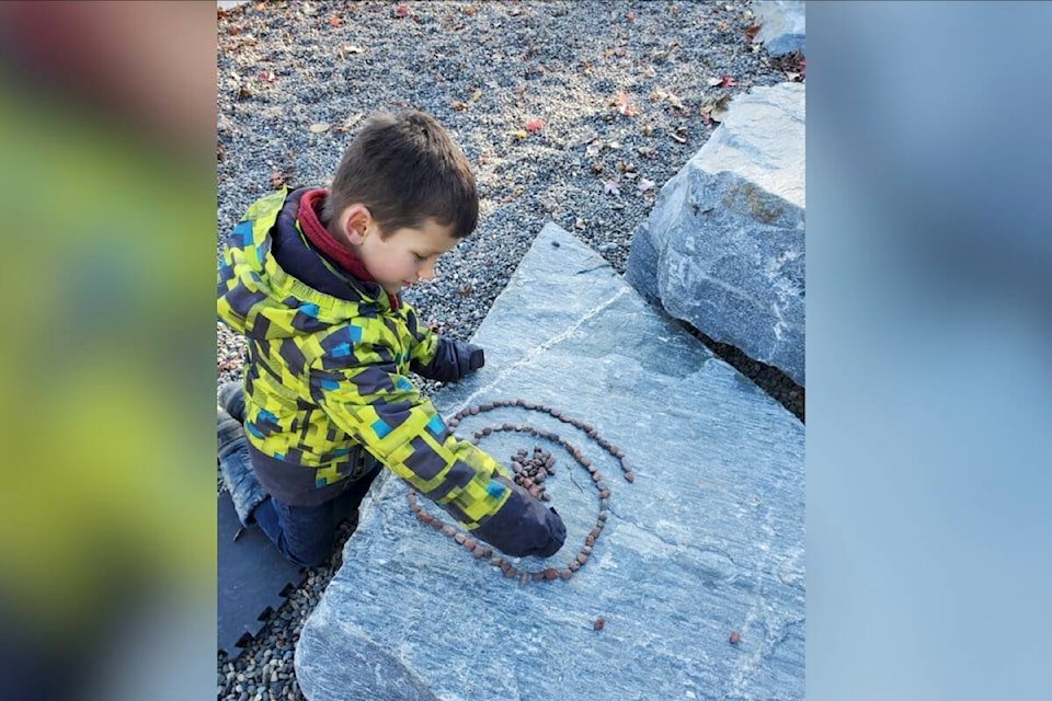 Nathaniel Gaynor making a design out of small stones as part of a NatureKids BC Salmon Arm explorer day. (NatureKids BC photo)