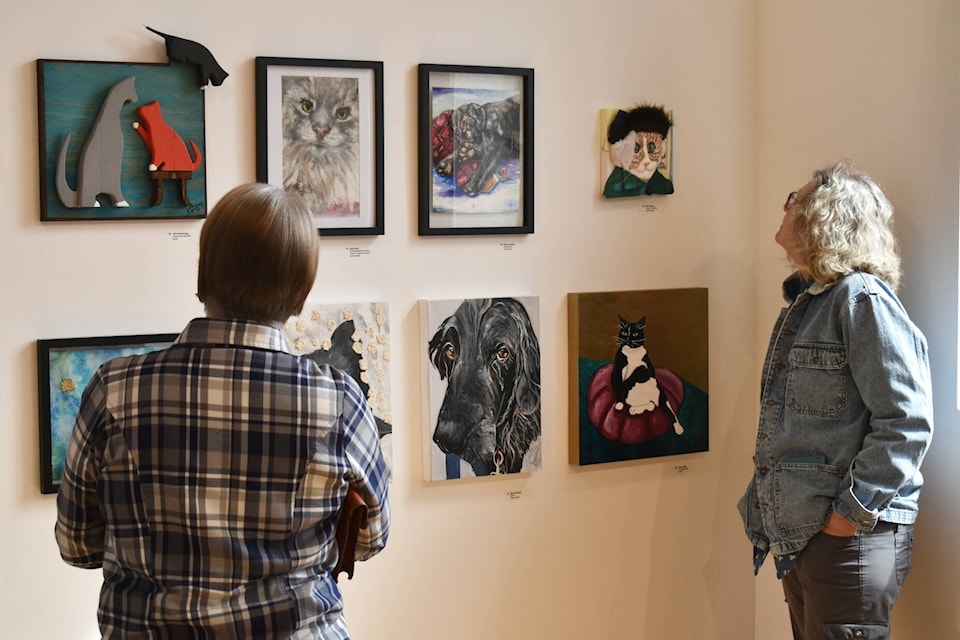 Patrons view some of the art at the opening of SPOT: All About Cats and Dogs at the Salmon Arm Art Gallery, Saturday, April 15, 2023. (Rebecca Willson/ Salmon Arm Observer)