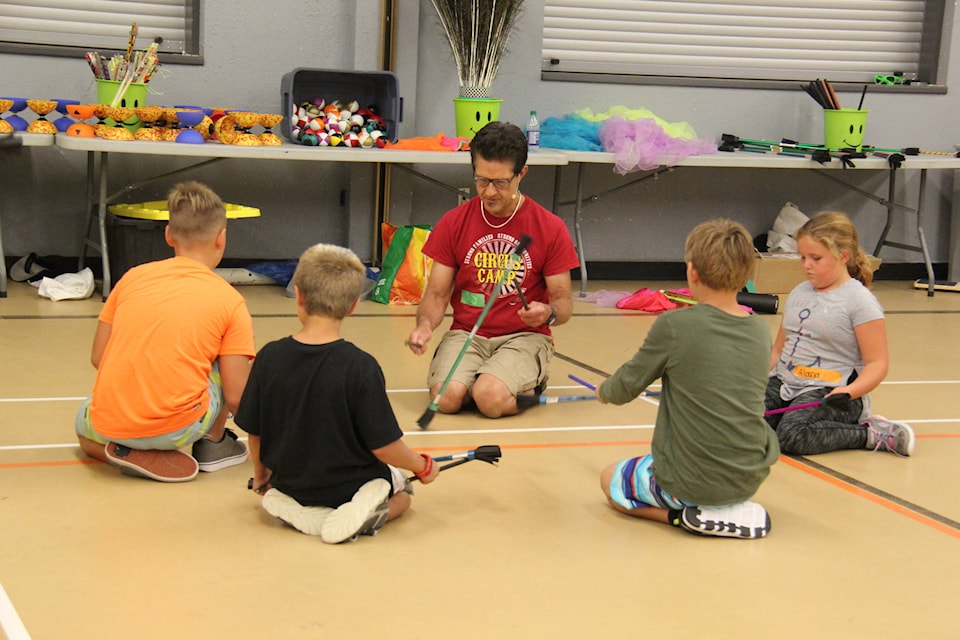 Bob Palmer teaches 17 children different techniques and tricks to be a circus performer during the Circus Arts Camp at the Family and Community Centre. The children participating in the week long camp learned tricks with flower sticks like the “tick-tock”. Photo by Megan Roth/Sylvan Lake News