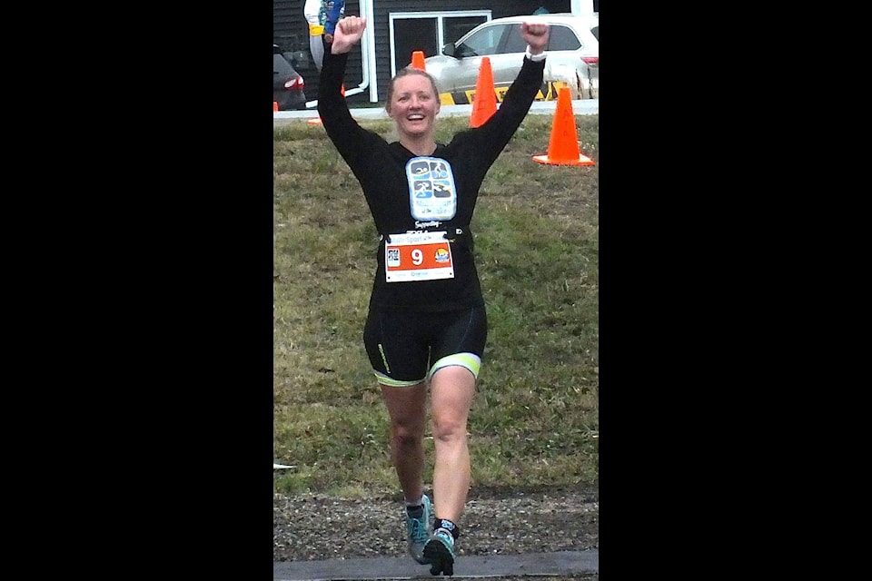 All smiles and happy one participant crosses the finishline during the first annual MultiSport at the Lake, Aug. 4. Photo by Paul Johnston/Sylvan Lake News.