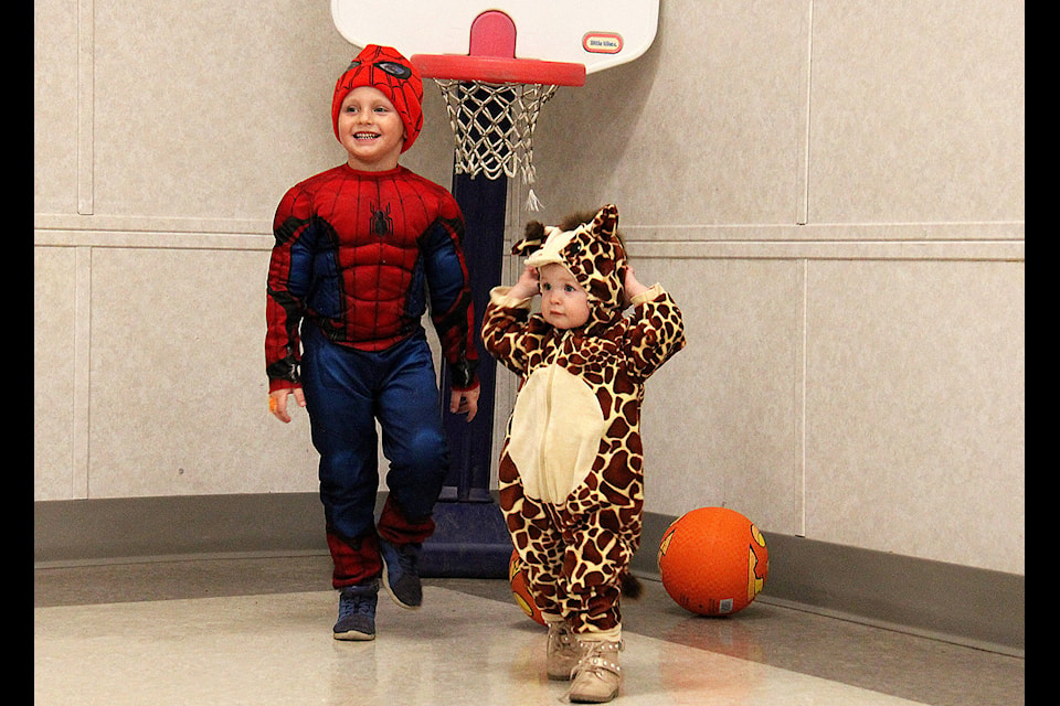 Cash, five, and his little sister Eve, one, attended the Eckville Halloween Party on Oct. 31. The party featured several games such as basketball and bowling for kids to play in exchange for candy. The event offered an indoor alternative to trick-or-treating to provide a warmer and safer environment. Photo by Kaylyn Whibbs/Eckville Echo