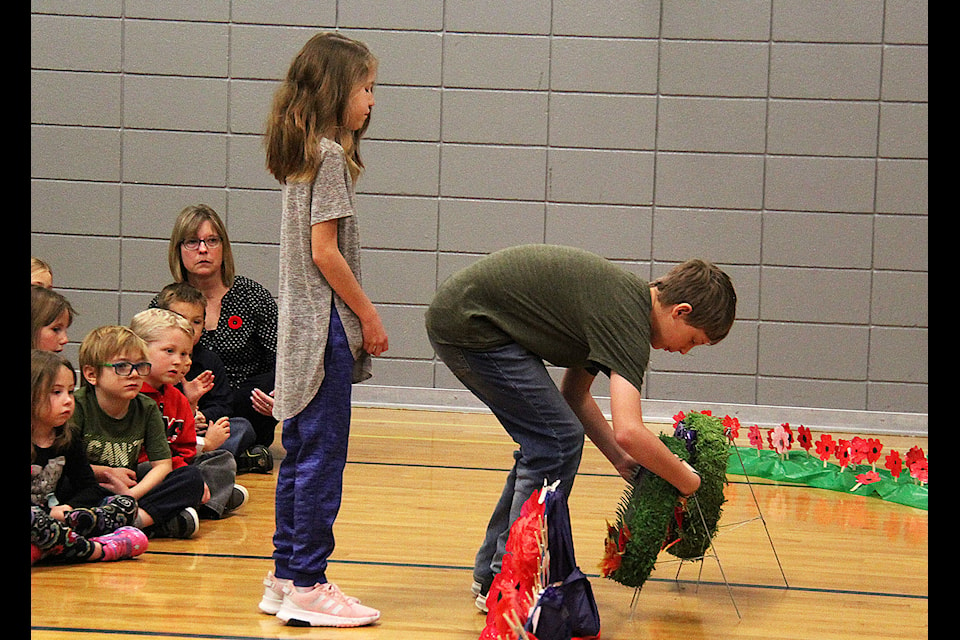 Cayli Lawrence and Jon Elliott lay one of four wreaths at the school’s Remembrance Day ceremony on Nov. 8. The wreaths were laid after the playing of The Last Post and the two minutes of silence by Grade 6 students. Photo by Kaylyn Whibbs/Eckville Echo