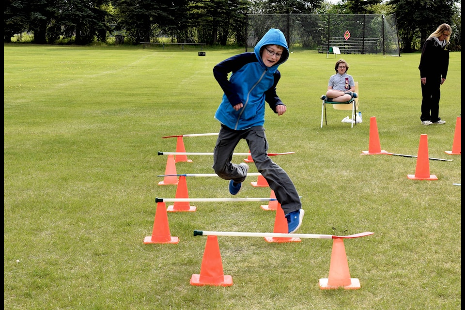 Chase Muddle leaps over hurdles at Eckville Elementary School’s Sports Day on June 7. The students spent the day outside participating in different activities ranging from Track and Field events to jump rope and tug-of-war. Photo by Kaylyn Whibbs/Eckville Echo