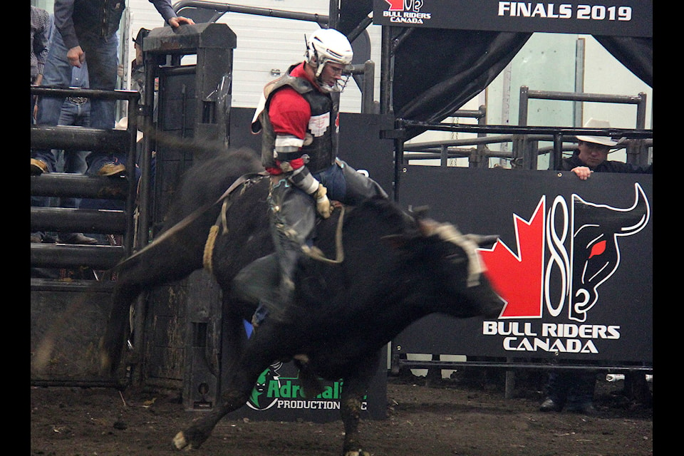 Justin Siemens holds on as the bull he is riding bursts from the gate in the championship round, Saturday night. Rimbey’s Siemens was one of two cowboys from the Alberta town to make it to the finals.