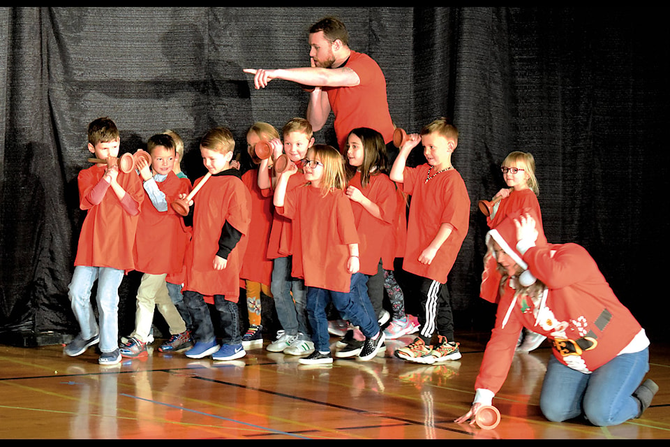 Grade 1 students use plungers as flash lights while performing the “Santa Boot Camp” skit on Dec. 13. The performance came after a week-long residency to make “Gifts to the World” with Trickster Theatre. Photo by Kaylyn Whibbs/Eckville Echo