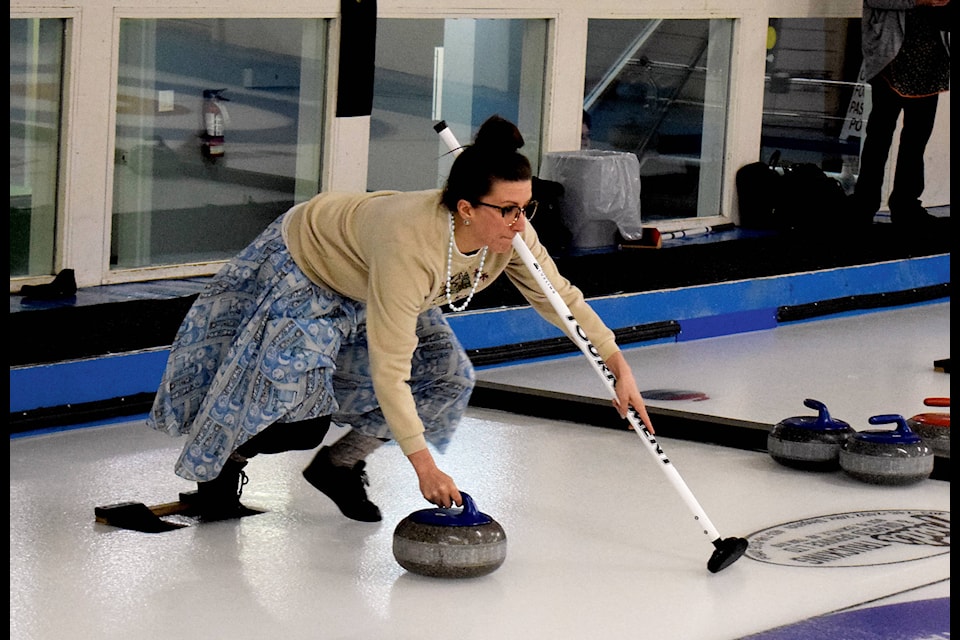 A curler pushes out of the hack looking to send the rock down ice at the Ladies Bonspiel in the Eckville Curling Club on Feb. 29. Photo by Kaylyn Whibbs/Eckville Echo