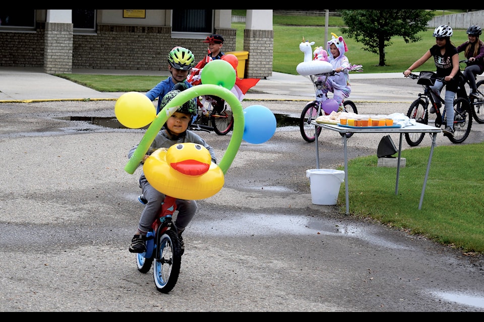 Kyptin Saarella, five, leads a bike parade for outside of the Eckville Manor House on July 24. Photo by Kaylyn Whibbs/Eckville Echo