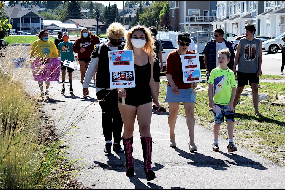 Participants of the third annual Walk a Mile in Her Shoes strutted from the lighthouse to the pier and back in heels and masks to raise awareness for domestic violence on Aug. 21. The annual event is organized by the Sylvan Lake Rotary Club and the HJ Cody Interact Club. Photos by Kaylyn Whibbs/Sylvan Lake News