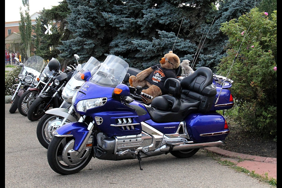 Motorcycles and other vehicles lined the Library parking lot Thursday evening, many of which had child-firendly decorations such as teddy bears, for a bike rally. Photo by Megan Roth/Sylvan Lake News