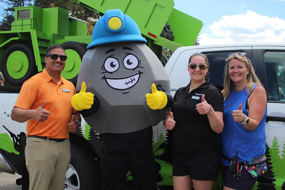 From left, Sparwood councillors Sam Atwal and Amy Cardozo, and organizer Marcia Johnson stand with the event's new mascot Cole.