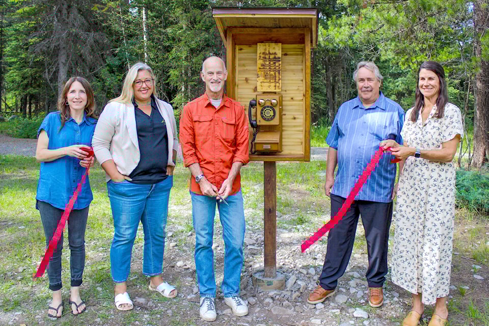 From left, Elk Valley & Area Hospice Society secretary Dayna Lidster, District of Elkford councillor Shawna Bryant, Elkford mayor Steve Fairbairn, councillor Duncan McDonald, and Hospice Society coordinator Jade Elford, cut the ribbon at the grand opening of three new wind phones on July 28.  (Tasha Chorneyko/District of Elkford)