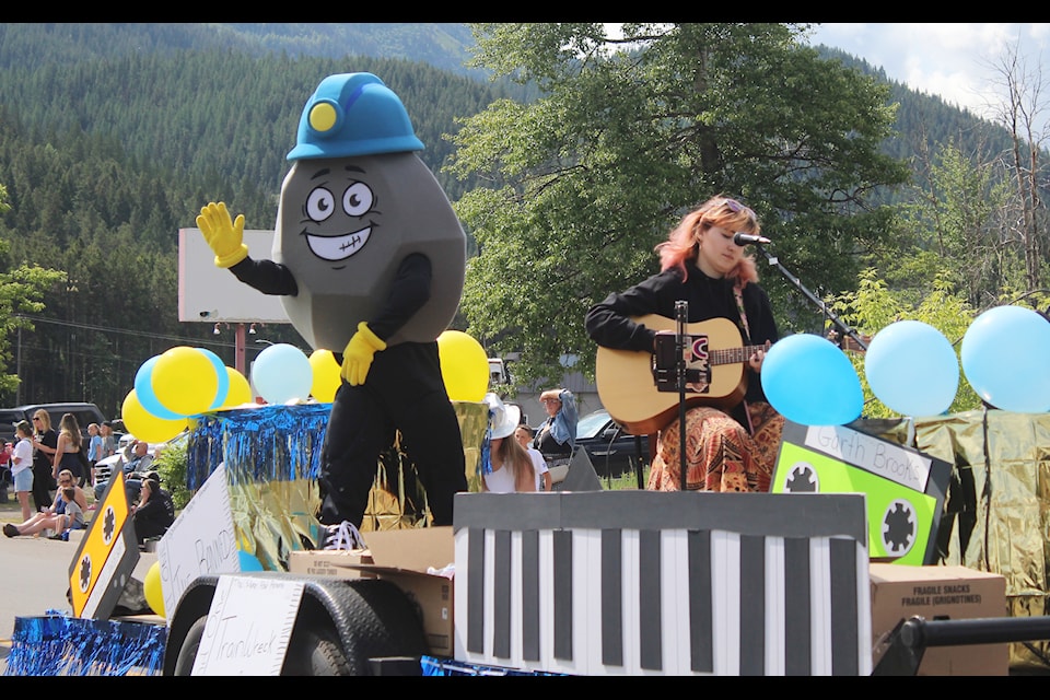 Mascot Cole waves at the crowd at the Coal Miner Days parade (Gillian Francis/TheFreePress)