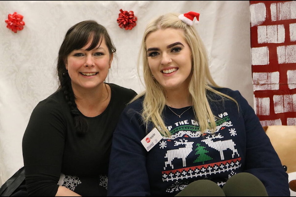 Red Apple store manager Stacey Bickford alongside employee Olivia English. The store’s Christmas Toy Drive wrapped up on Saturday, Dec. 11, 2021. (Joshua Fischlin/The Free Press)