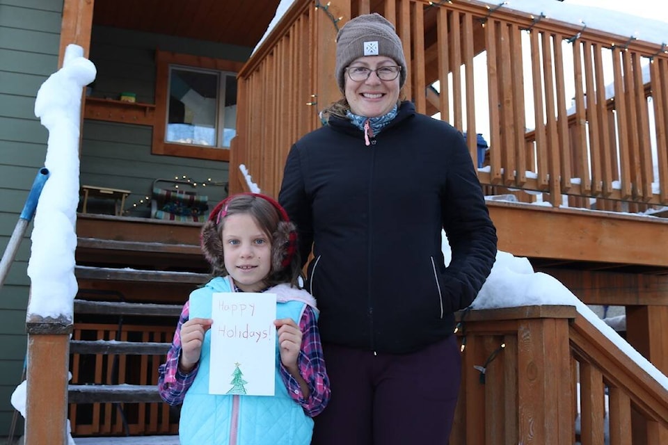 Anna and Katya Choroszewski were busy delivering newspapers and Christmas cards to 55 people on Dec. 16, 2021. (Joshua Fischlin/The Free Press)