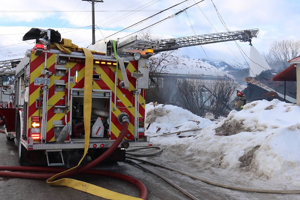 A fire crew douses a destroyed building in Fernie on 6th Ave. to put out flames on Wednesday, Feb. 9, 2022. (Joshua Fischlin/The Free Press)