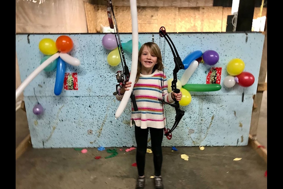 Elizabeth Leberge is all smiles after popping a prize balloon and winning a fishing rod and reel combo at the Elkford Rod and Gun Club’s Intro to Archery at Elkford’s Winter in the Wild weekend. (Dylan Forsyth / Elkford Rod and Gun Club)