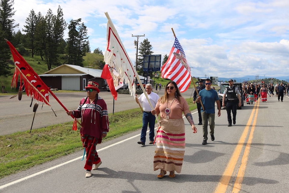 Chief Heidi Gravelle (right) and Councillor Kyle Shottanana leading the 25th Annual Border Cross Walk on foot at the Roosville Border Crossing on National Indigenous Peoples Day 2022. (Joshua Fischlin/The Free Press)
