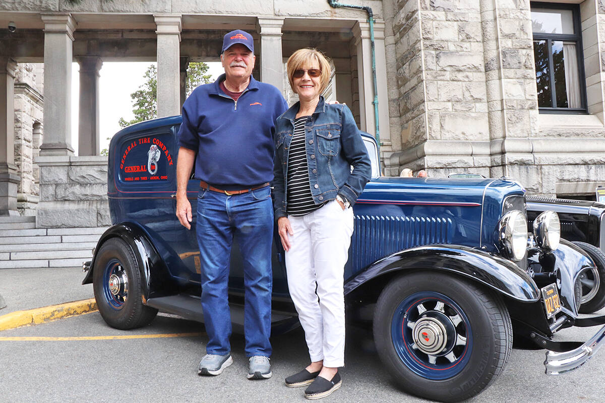 George and Karen Baur from Petaluma, Calif. stand with their restored 1932 Ford panel delivery van, on the legislature grounds Sunday during the Northwest Deuce Days show and shine. (Don Descoteau/News Staff)