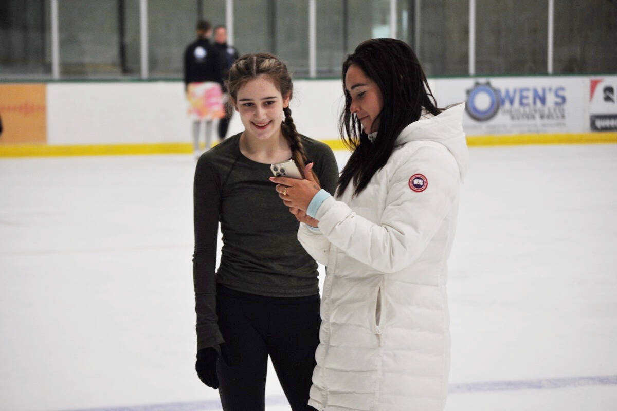Nelson skater Taylor Singer (left) reviews video of her jump with Kaetlyn Osmond at the Nelson and District Community Complex on Aug. 29. Photo: Tyler Harper